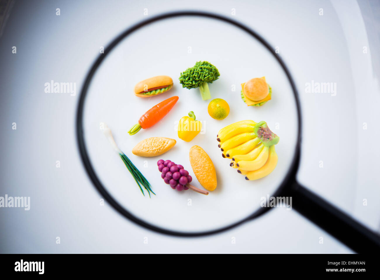 Food and magnifying glass. Stock Photo