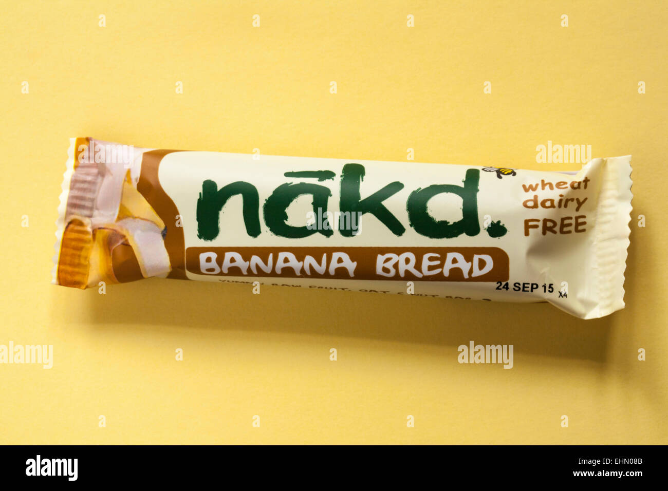 wheat dairy free nakd Banana Bread yummy raw fruit oat & nut bar isolated on yellow background Stock Photo