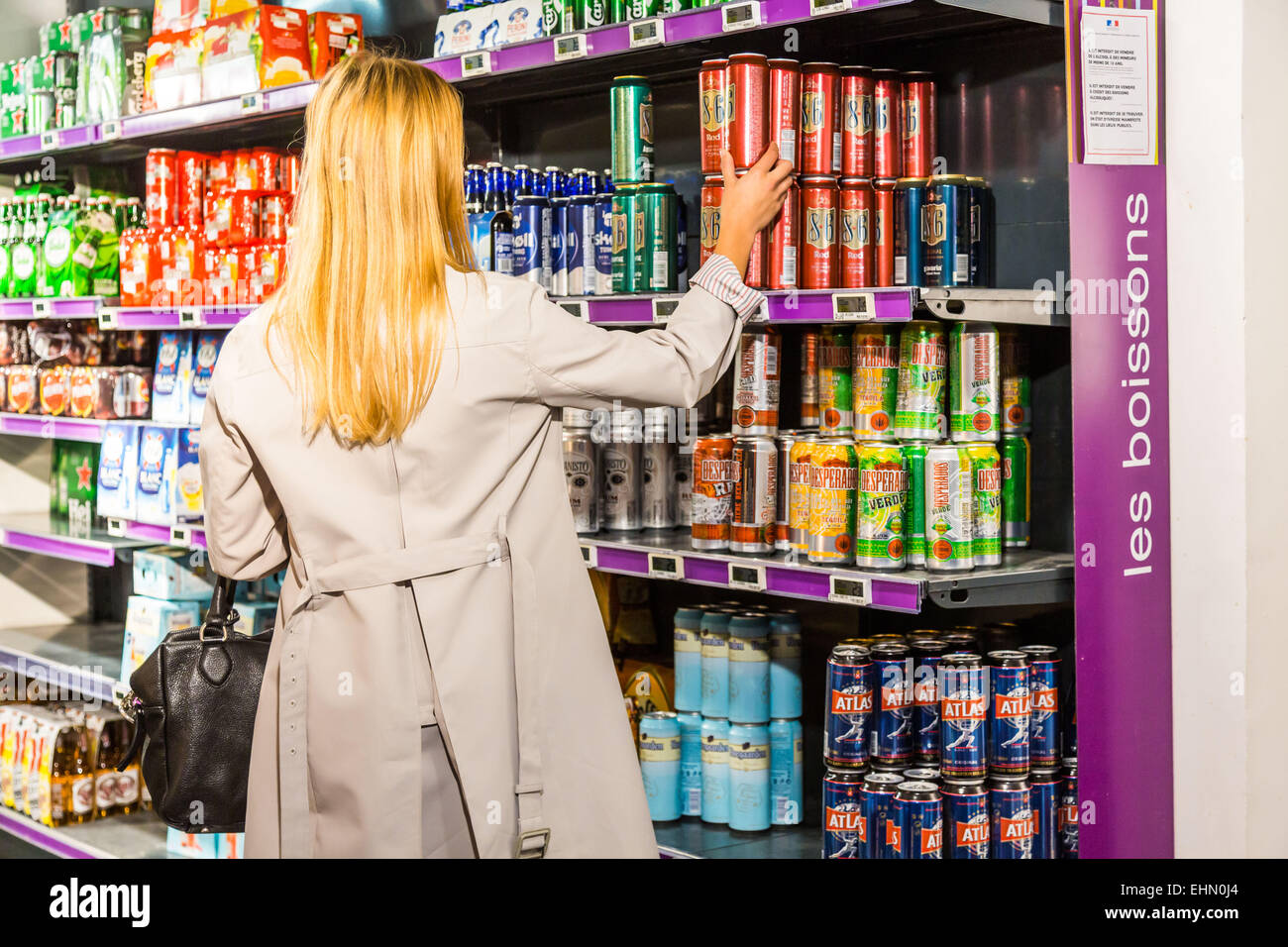 Woman in a supermarket. Liquors section. Stock Photo