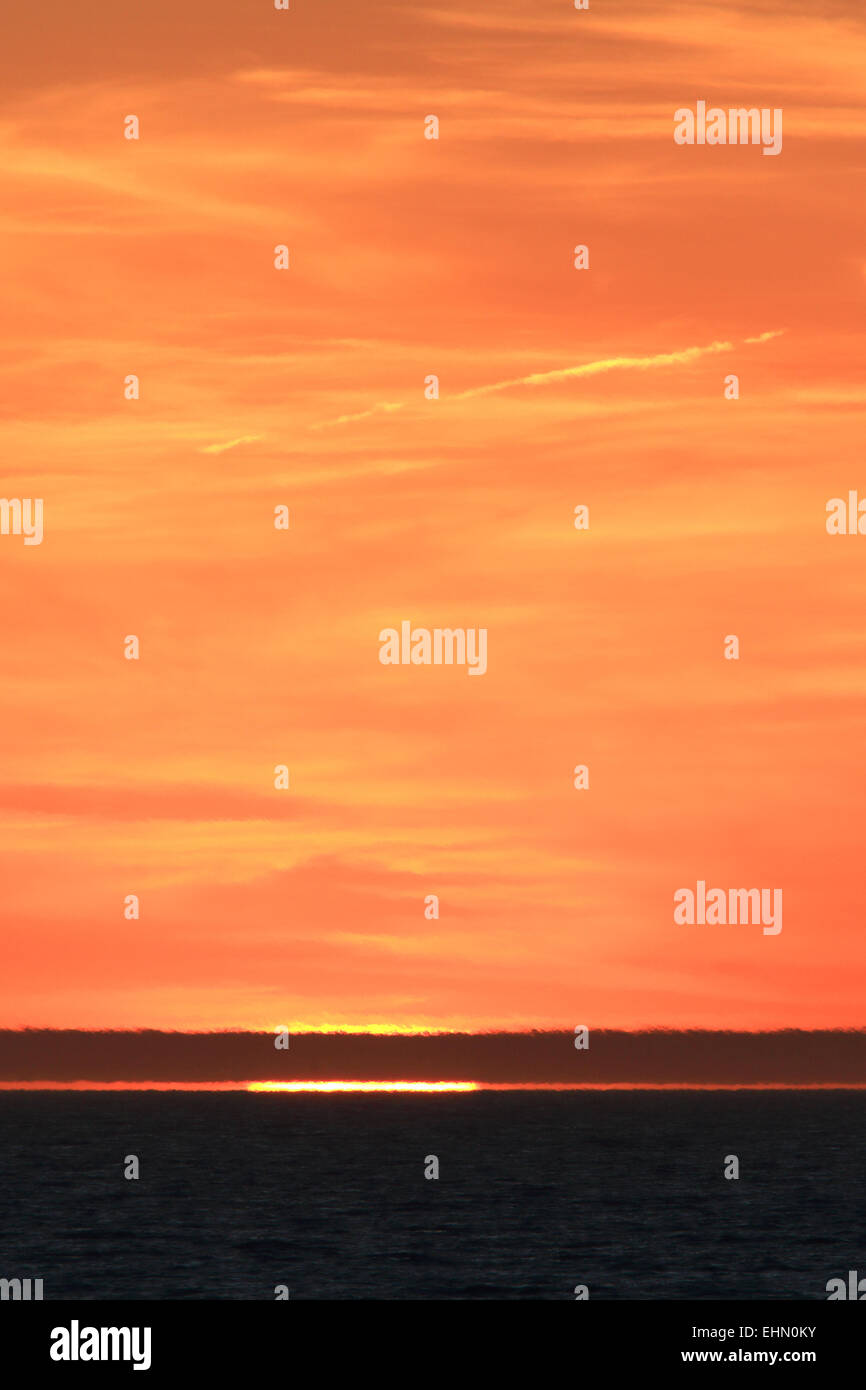 Sunset sky with sun colorful orange yellow sky landscape. Stock Photo