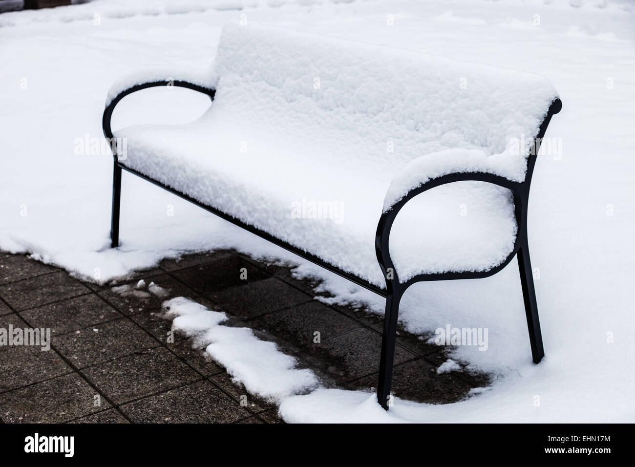 Bench covered in snow. Stock Photo