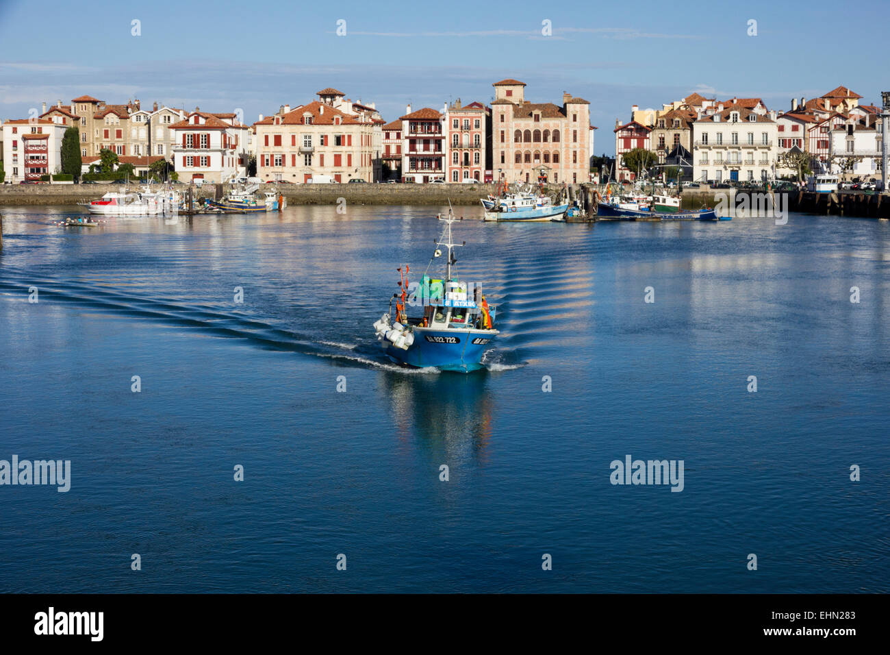 Small fishing boat returning to harbour, St Jean de Luz, Southern France Stock Photo