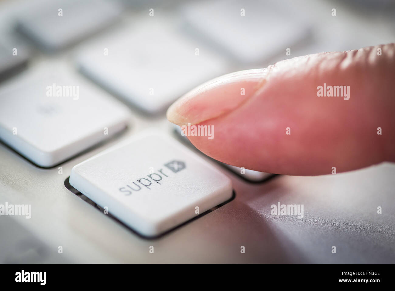 Woman pressing a button on a computer keyboard. Stock Photo