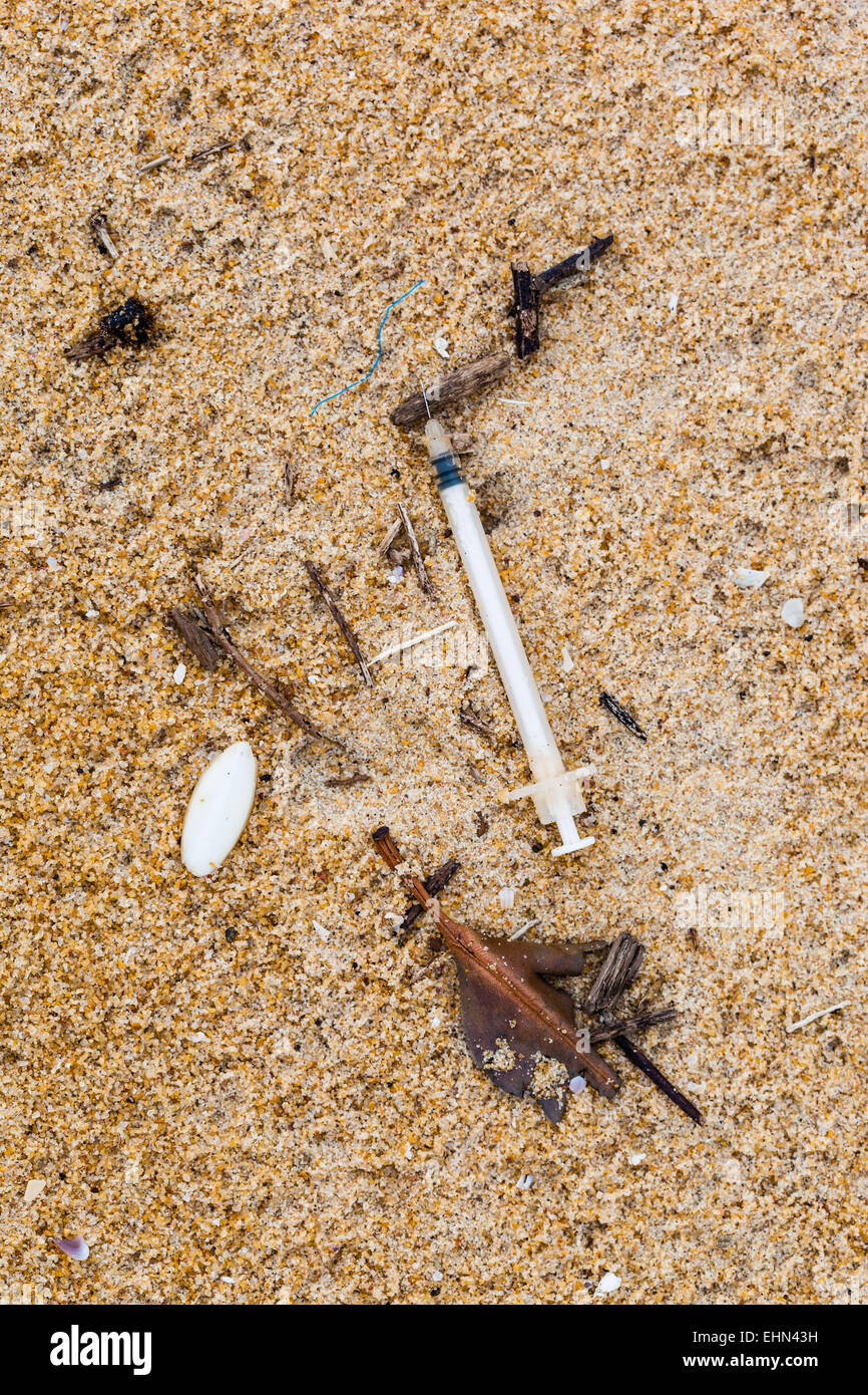 Syringe on a beach. Stock Photo