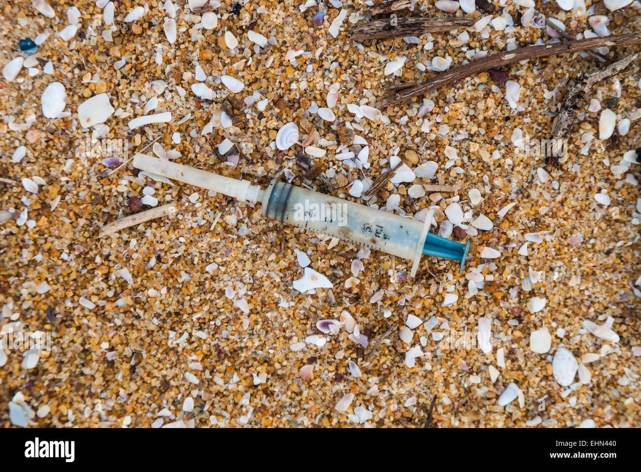 Syringe on a beach. Stock Photo