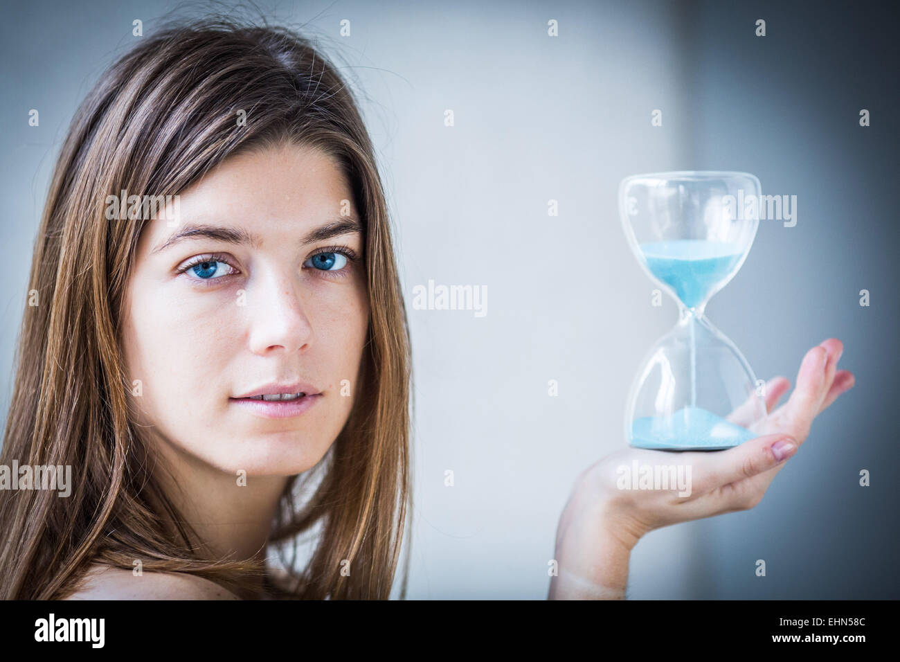 Woman holding an hourglass. Stock Photo