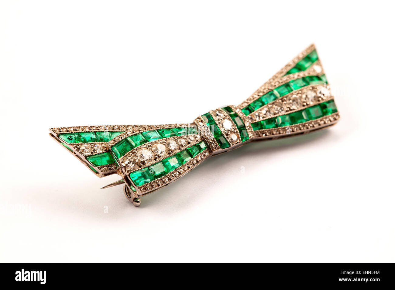 French platinum emerald and diamond bowtie brooch. Stock Photo