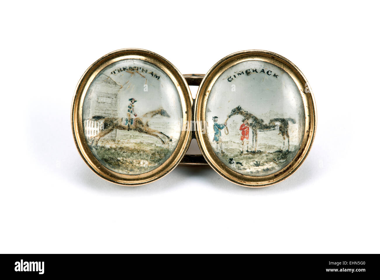 Double oval brooch depicting racehorses, originally cufflinks. Stock Photo