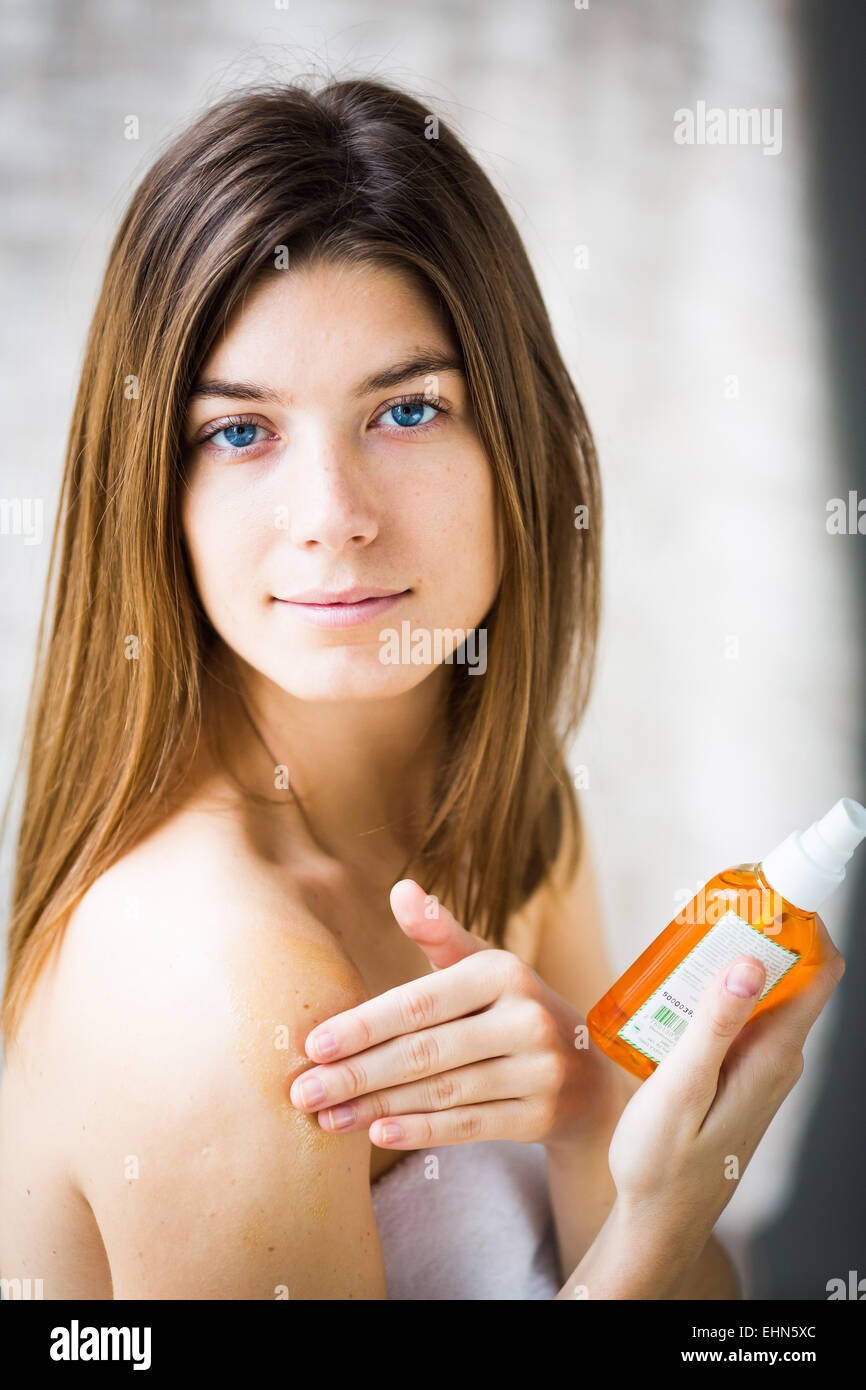 Woman using carrot oil. Stock Photo