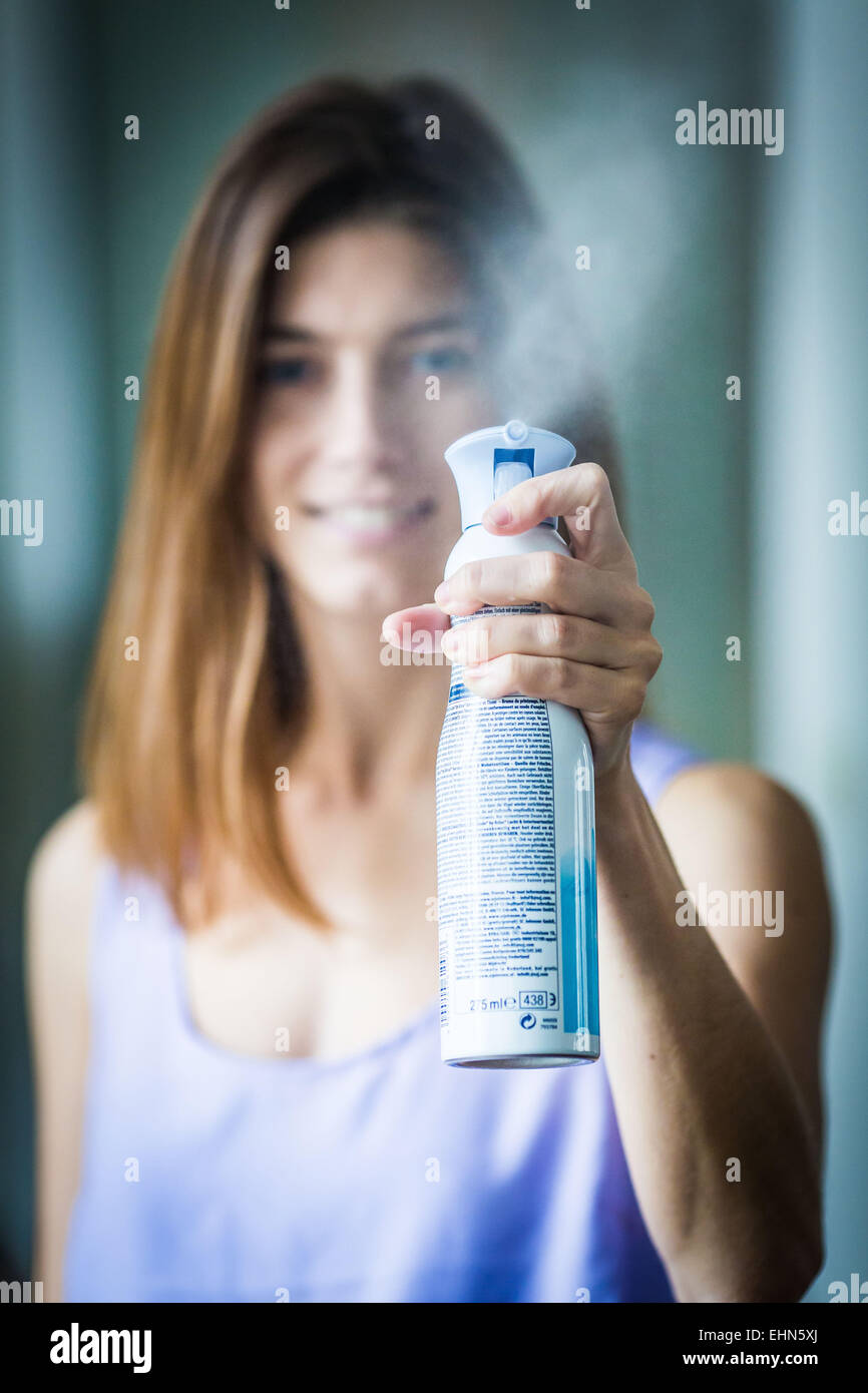 Woman using a deodorising. Stock Photo