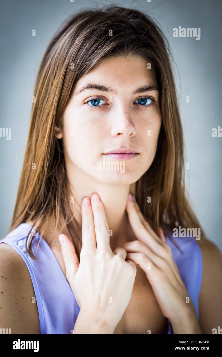 Woman self-examining her throat. Stock Photo