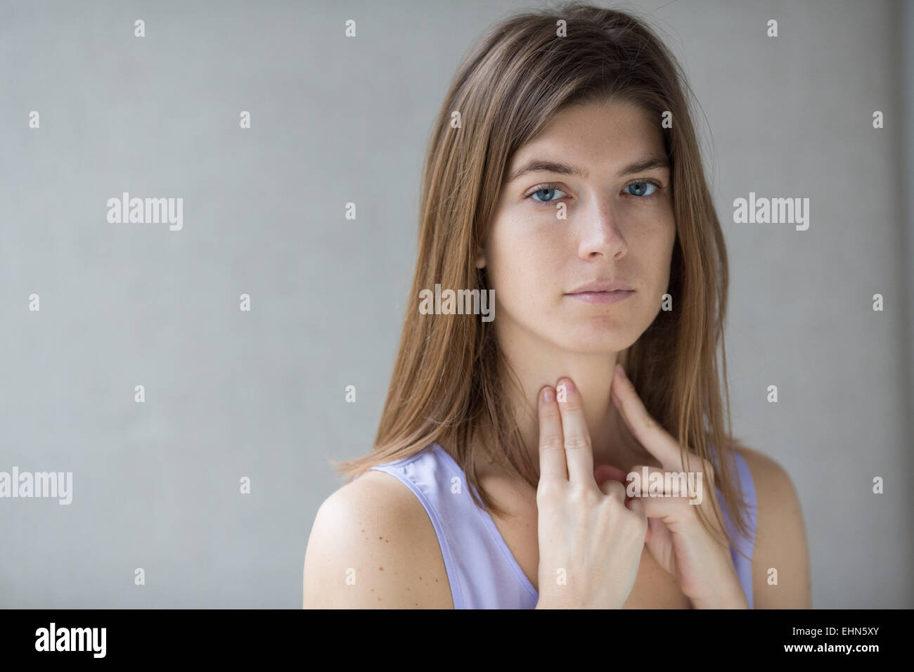 Woman self-examining her throat. Stock Photo