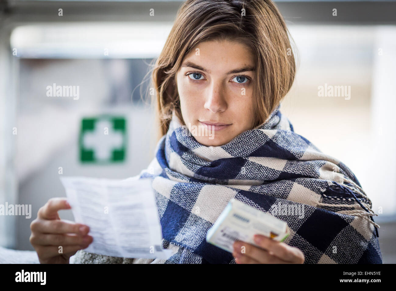 Woman reading medicine instruction sheet. Stock Photo