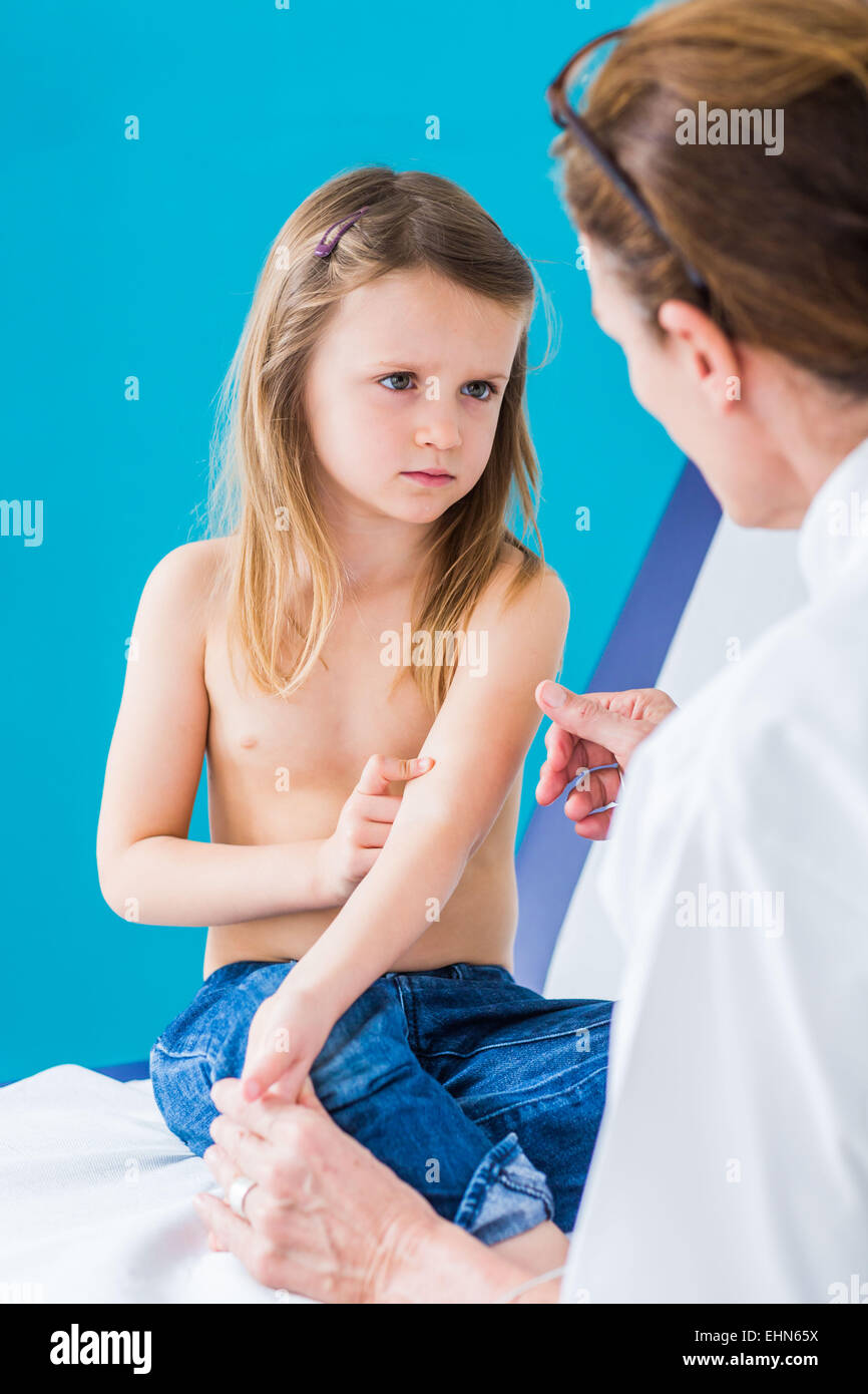Pediatrician examining the skin of a 4 year old girl. Stock Photo