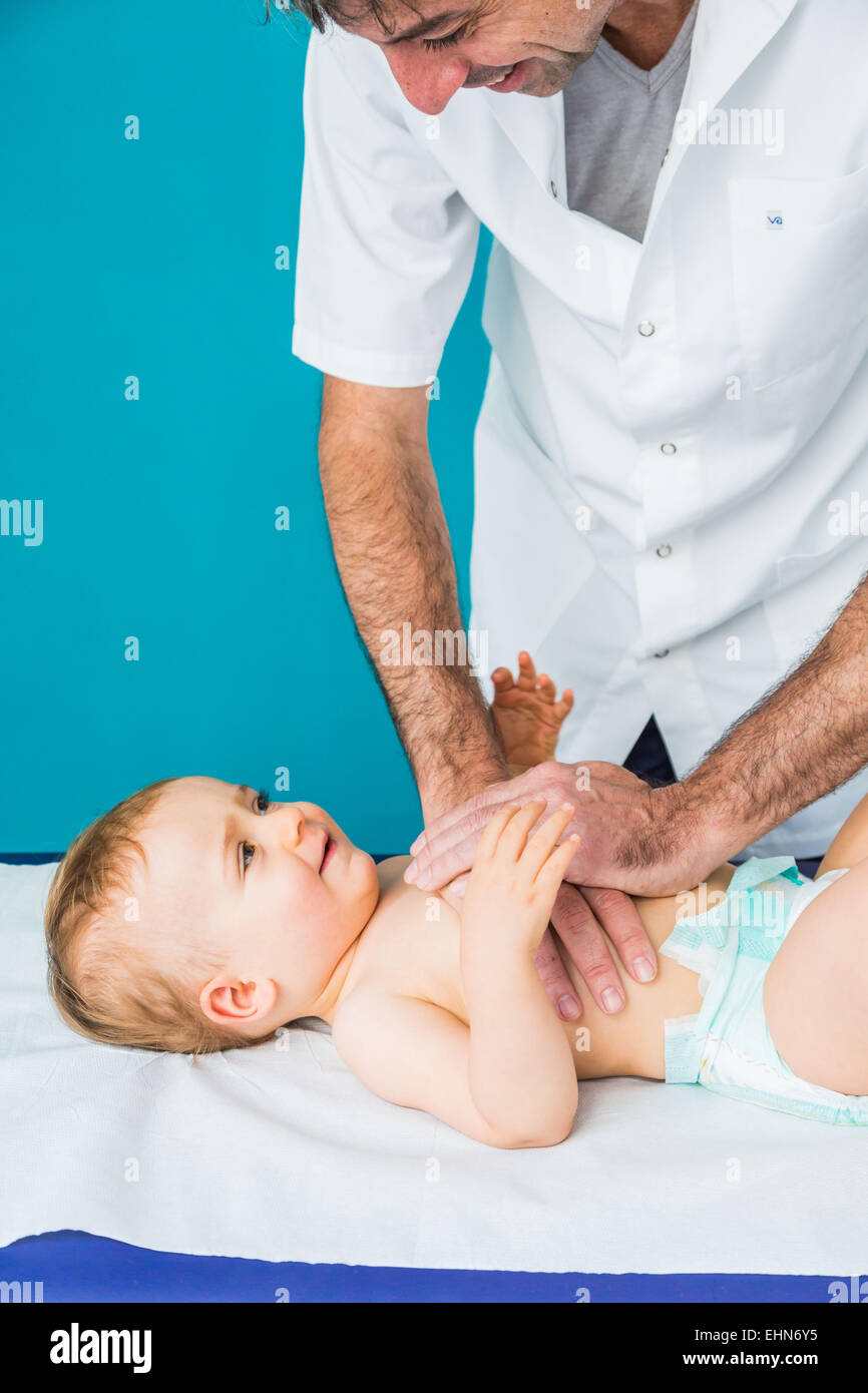 Doctor performing respiratory physiotherapy on a 13 months old infant. Stock Photo