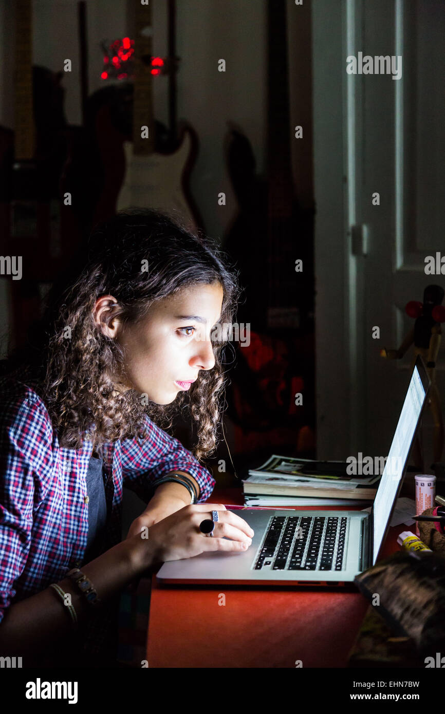 Teenage girl using a laptop computer. Stock Photo
