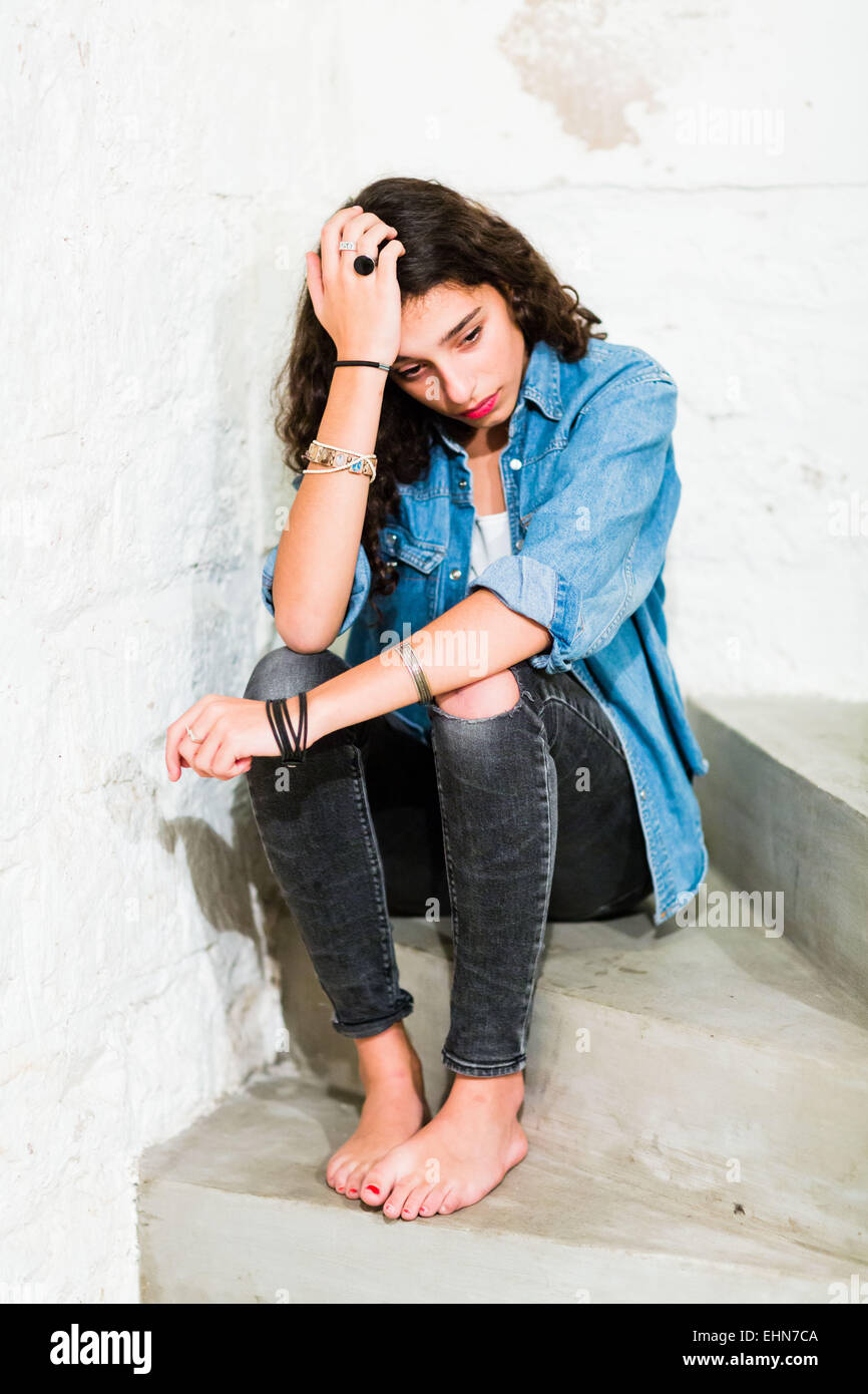 Sad depressed teen girl sitting hi-res stock photography and images - Alamy
