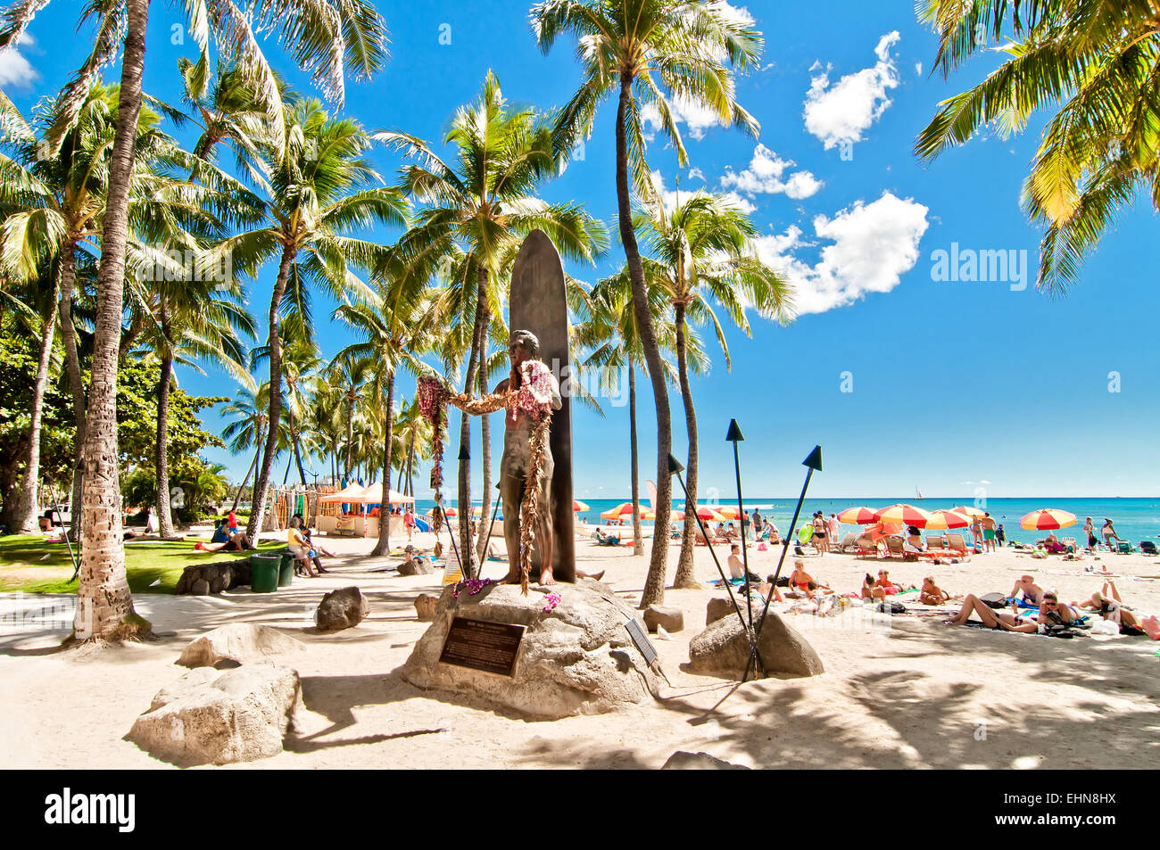 WAIKIKI, HAWAII - SEPTEMBER 7, 2013 Tourists sunbathing and surfing on Waikiki  in Honolulu, Hawaii. Waikiki white sand bea Stock Photo