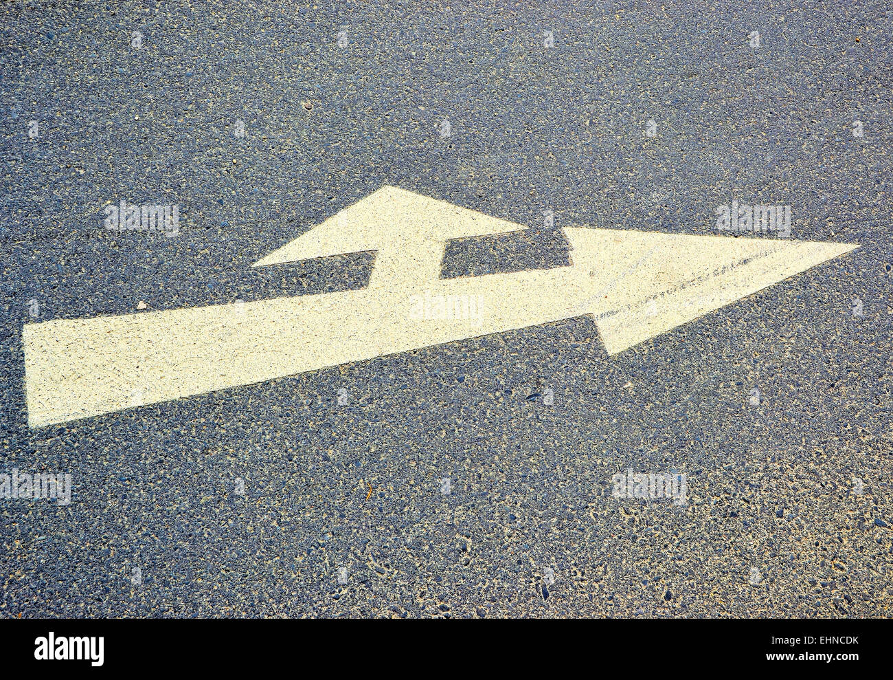 An arrow on the asphalt of a road Stock Photo