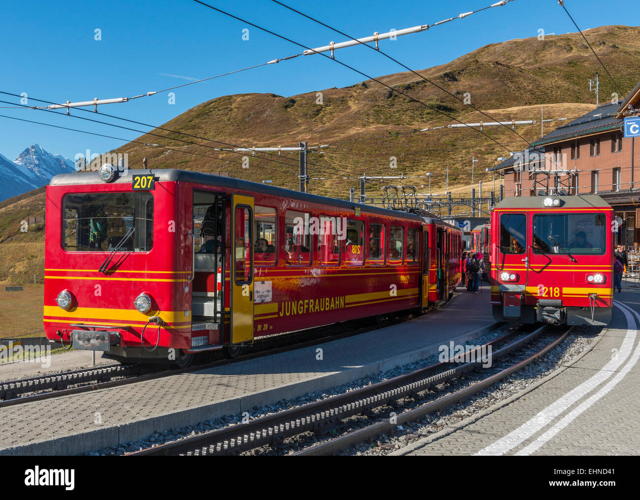 Red trains of the Jungfraubahn on the station Kleine Scheidegg in Switzerland. Stock Photo