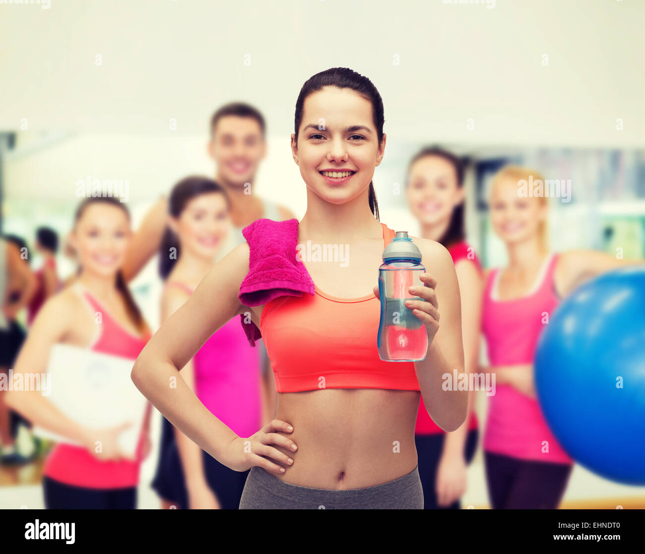 sporty woman with towel and water bottle Stock Photo - Alamy