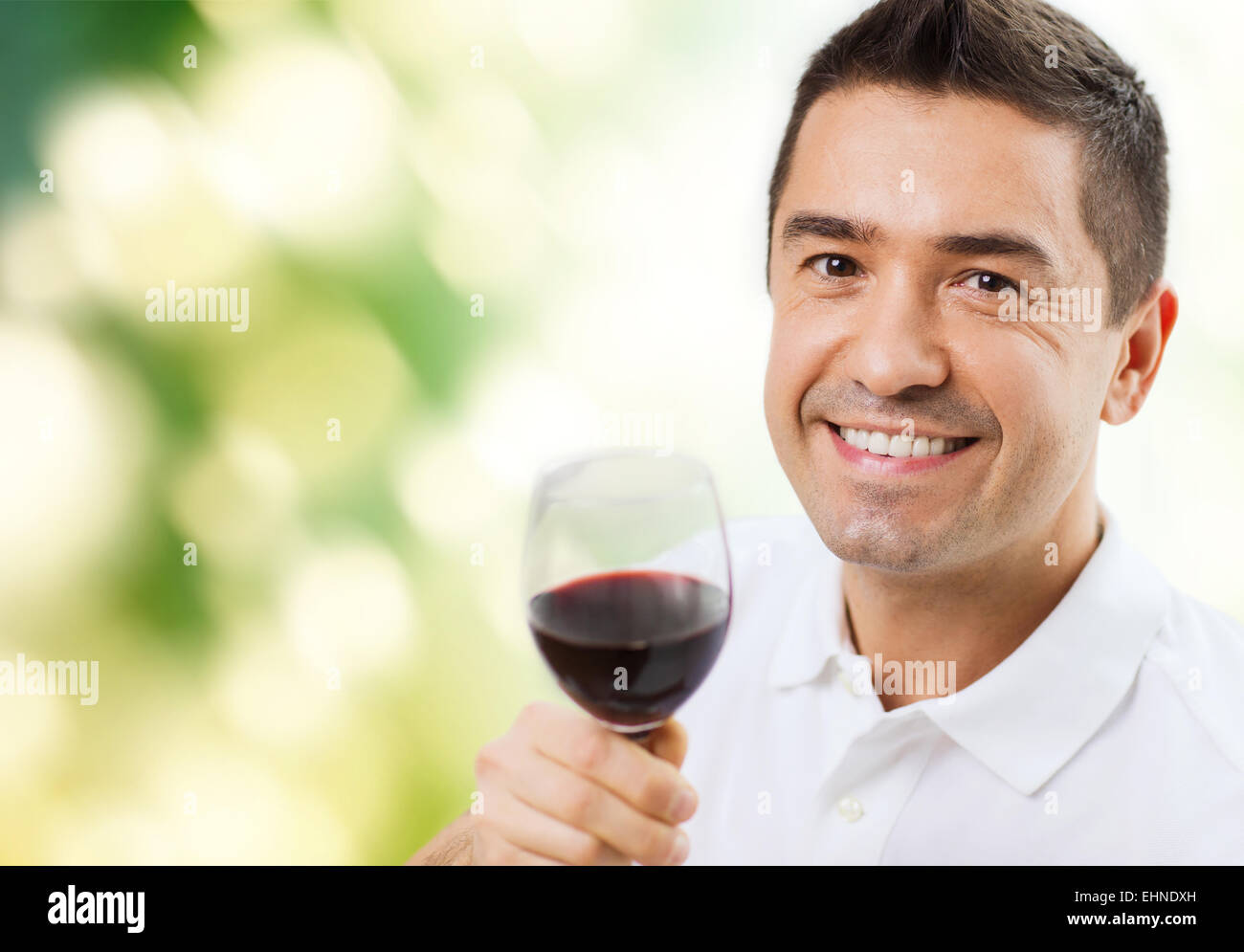happy man drinking red wine from glass Stock Photo - Alamy