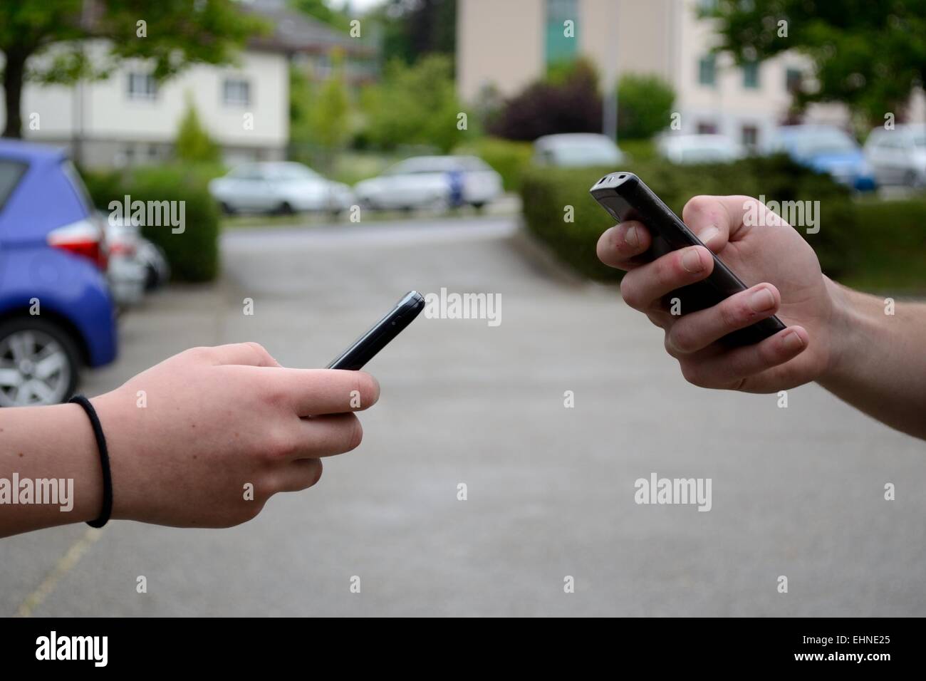 Two people communicate with the mobile phone Stock Photo