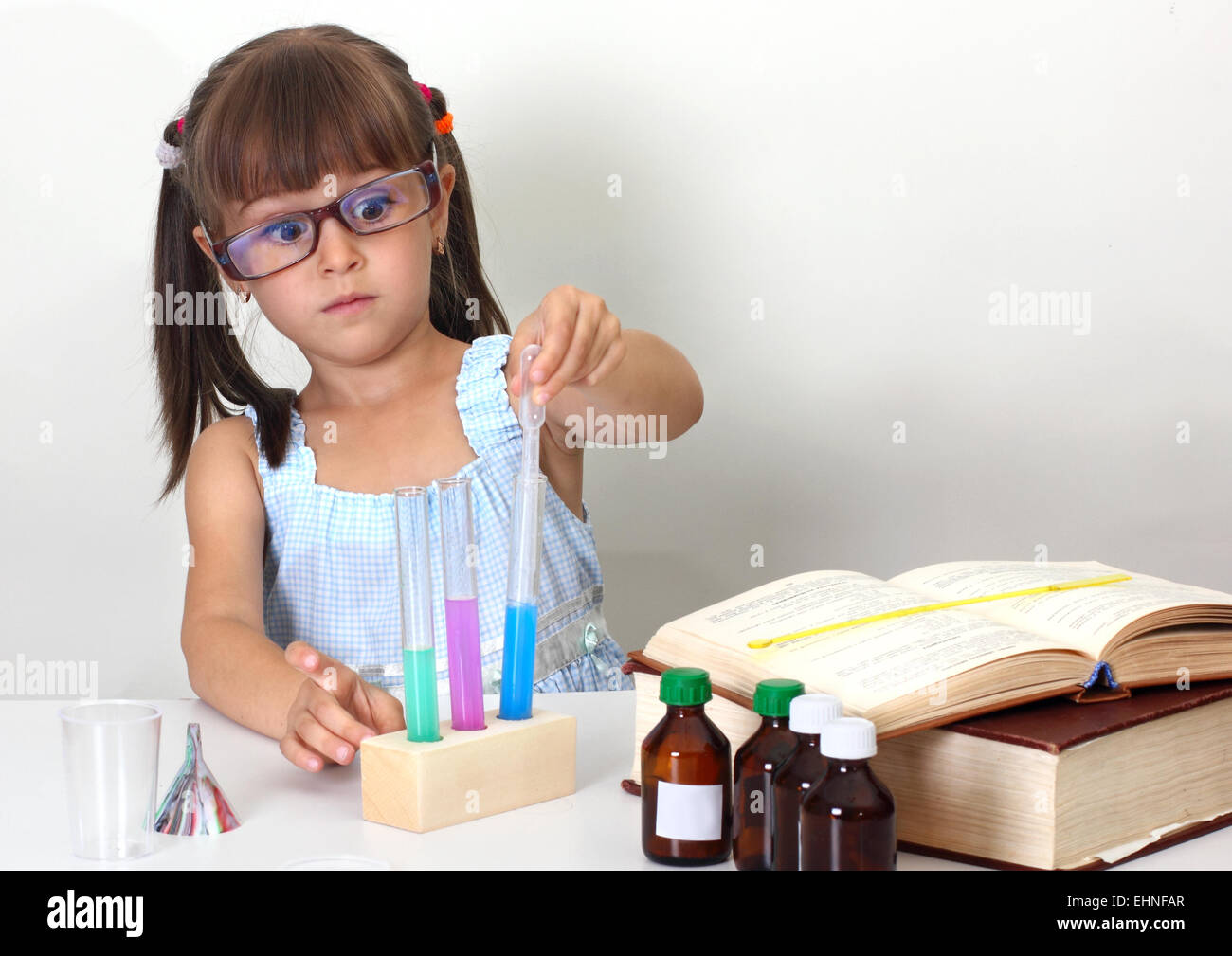 surprised child girl making sciencel test Stock Photo