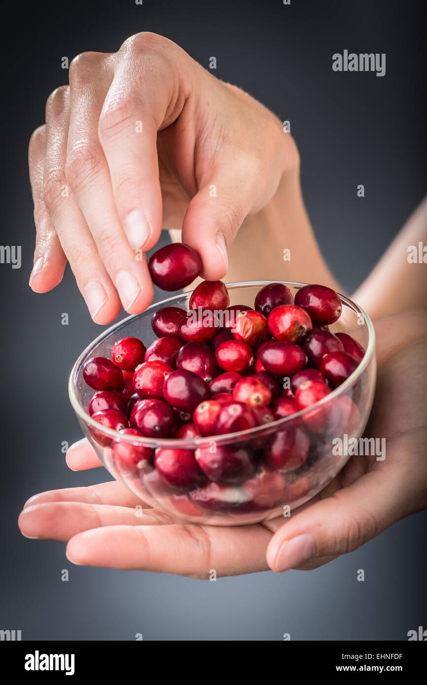 Woman eating dried cranberries Stock Photo Alamy