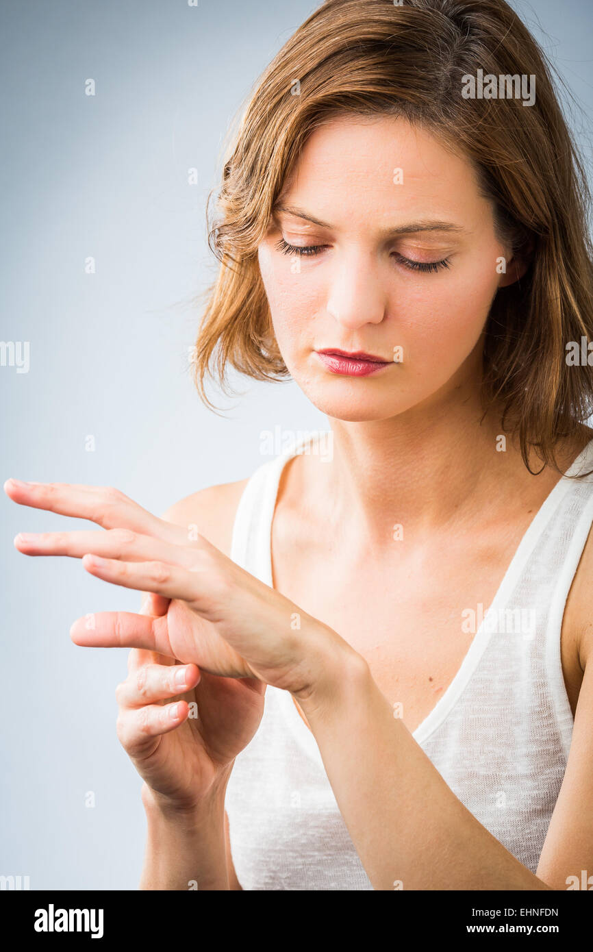 Woman inspecting her hand. Stock Photo