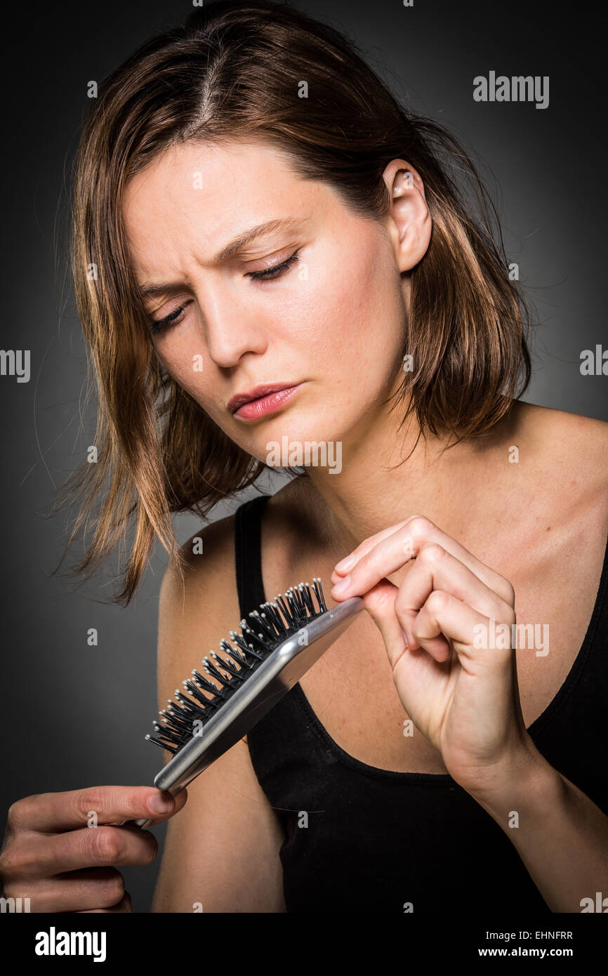 Woman brushing her hair. Stock Photo