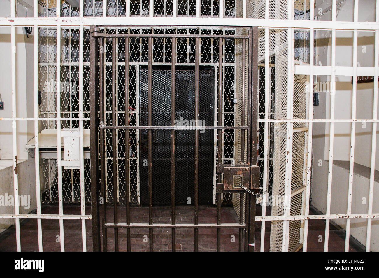 Metal barred gates inside an old prison Stock Photo