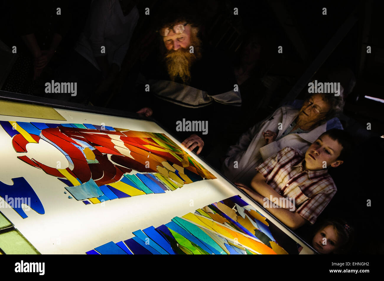 Visitors look on as they are given a demonstration on how to build