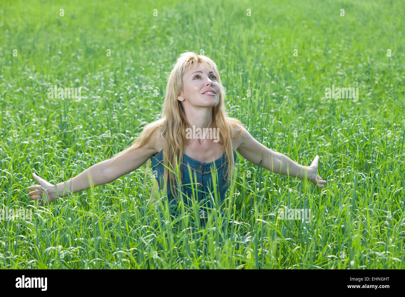 The happy young woman in the field Stock Photo