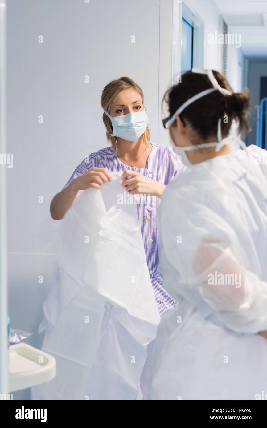 Nurse and student nurse (white suit), pediatric department of Angoulême hospital, France. Stock Photo