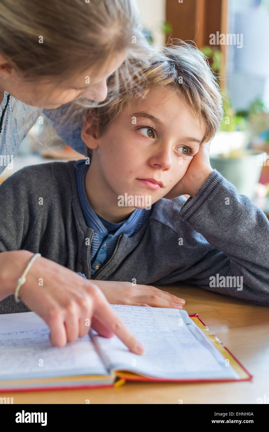 Mother checking homeworks of his son. Stock Photo