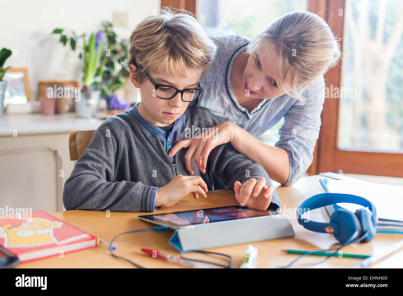 8 year old boy using tablet computer. Stock Photo