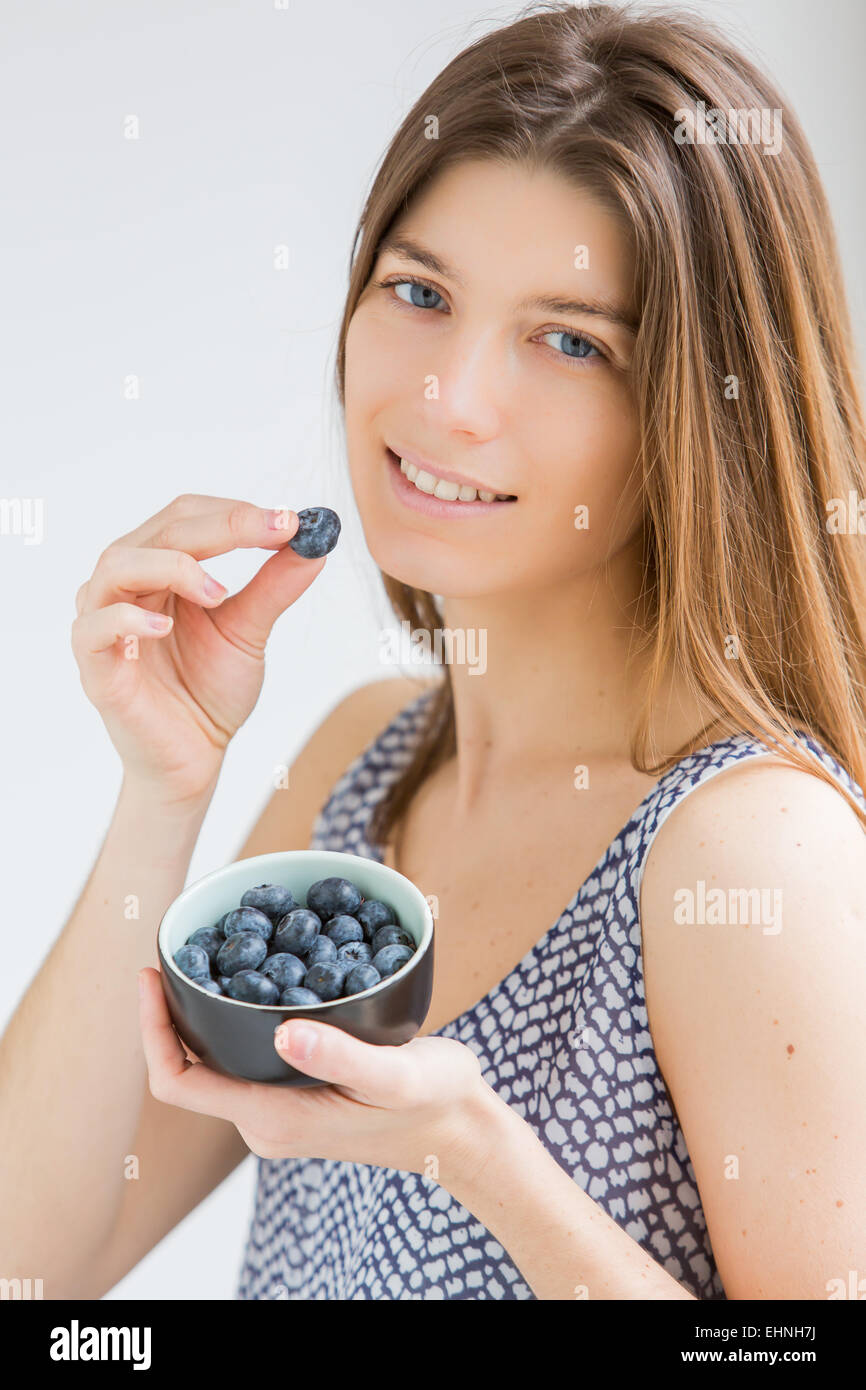 Woman eating blueberries. Stock Photo