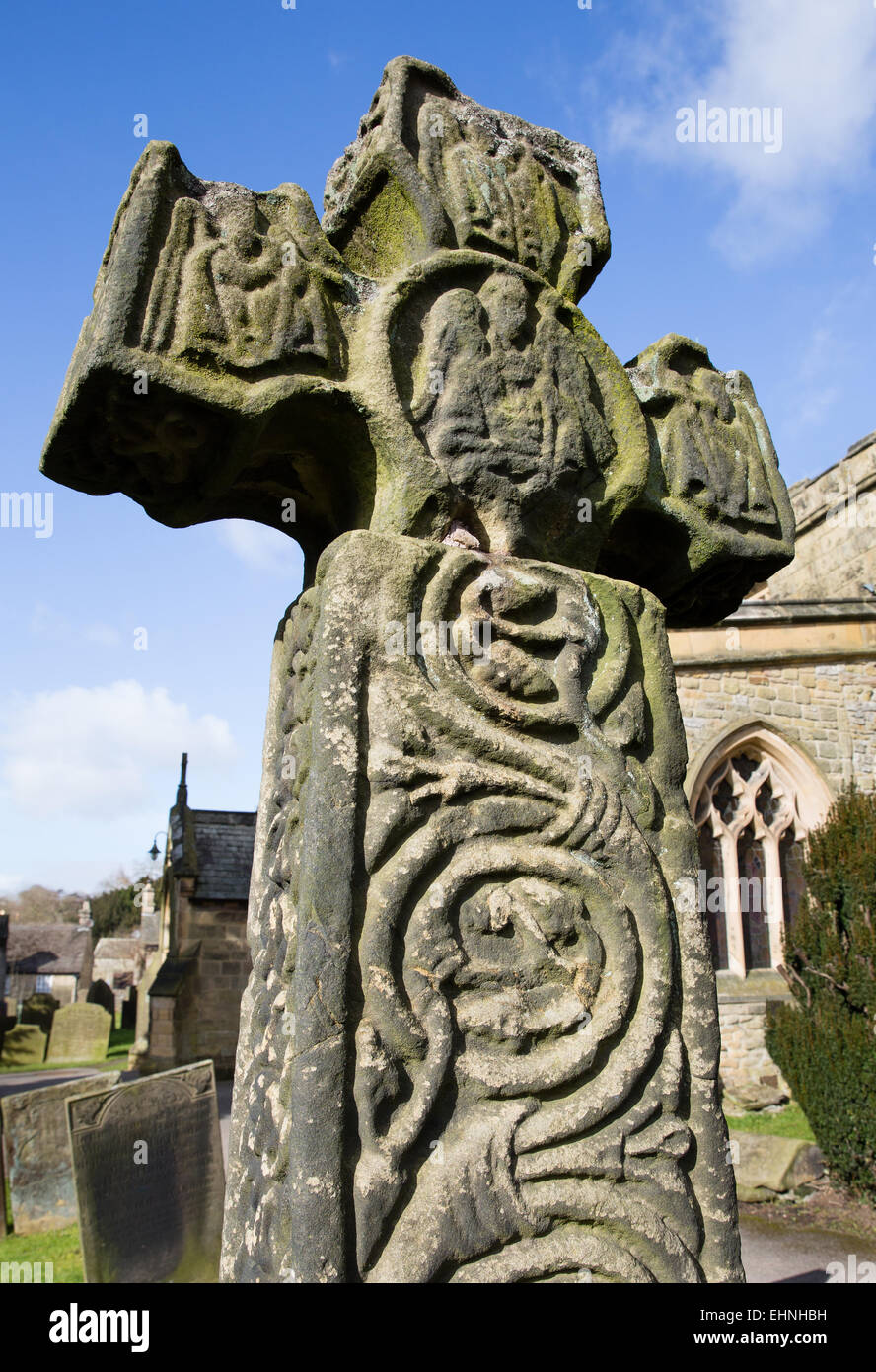 The 8th century Anglo Saxon or Celtic Cross in St Lawrence's churchyard at Eyam in the Derbyshire Peak District Stock Photo