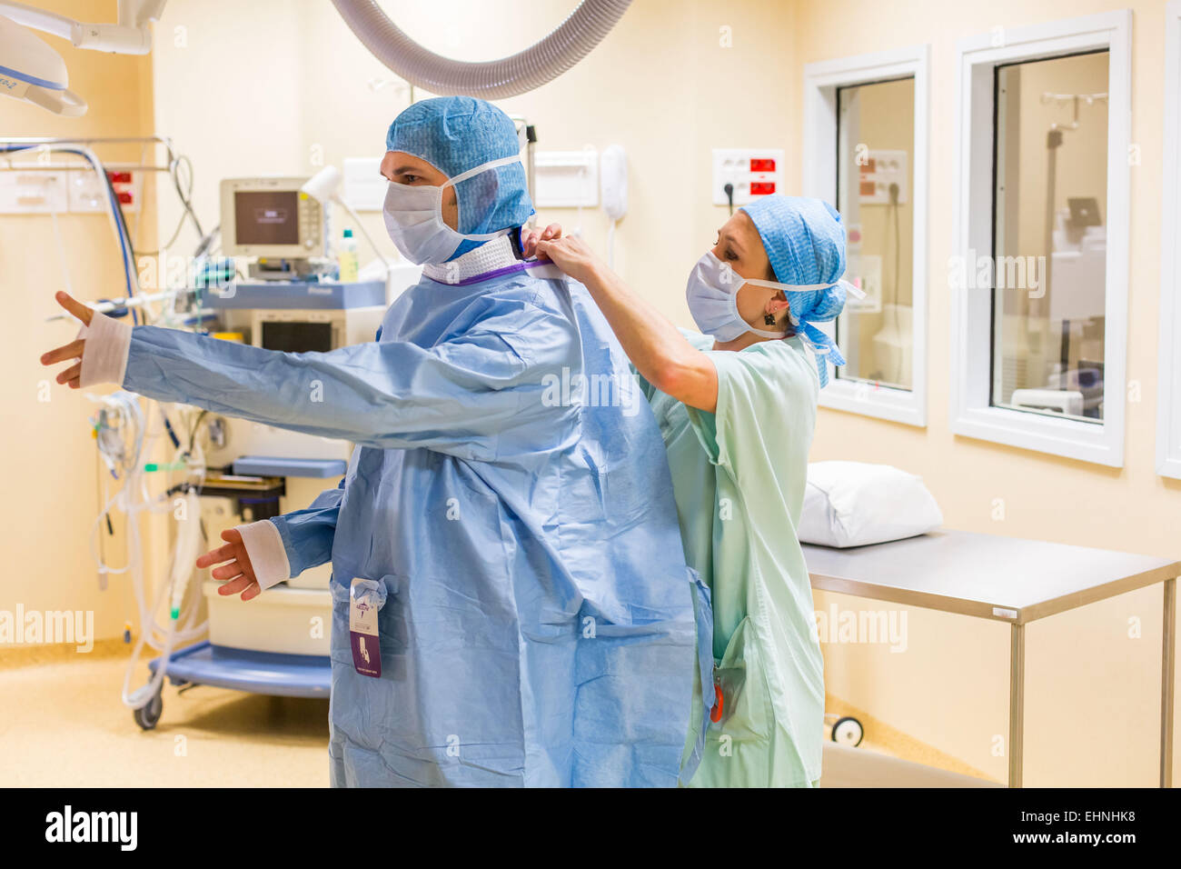 Surgical team getting dressed before surgery, Limoges hospital, France Stock Photo