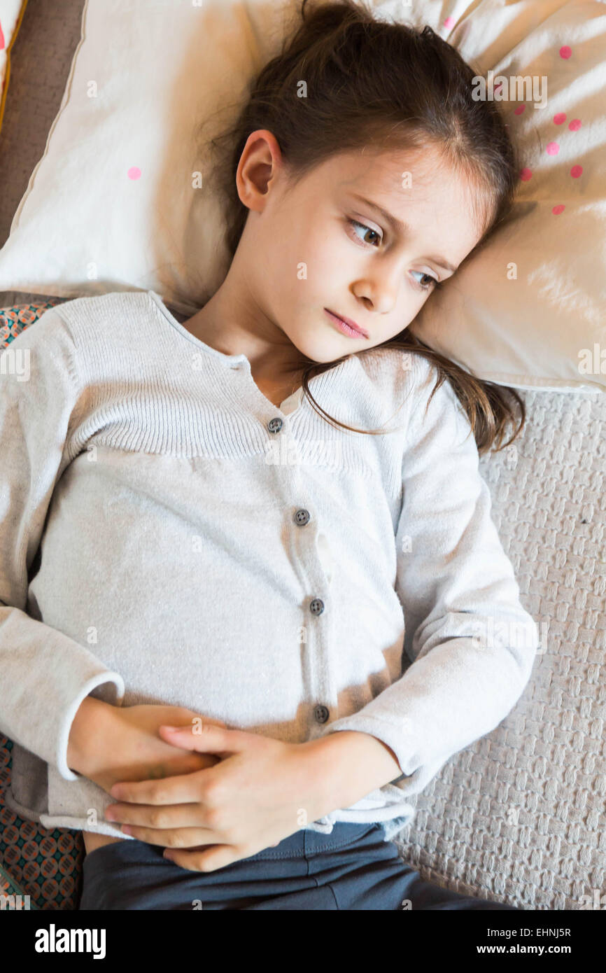 7 year-old child suffering from bellyache. Stock Photo