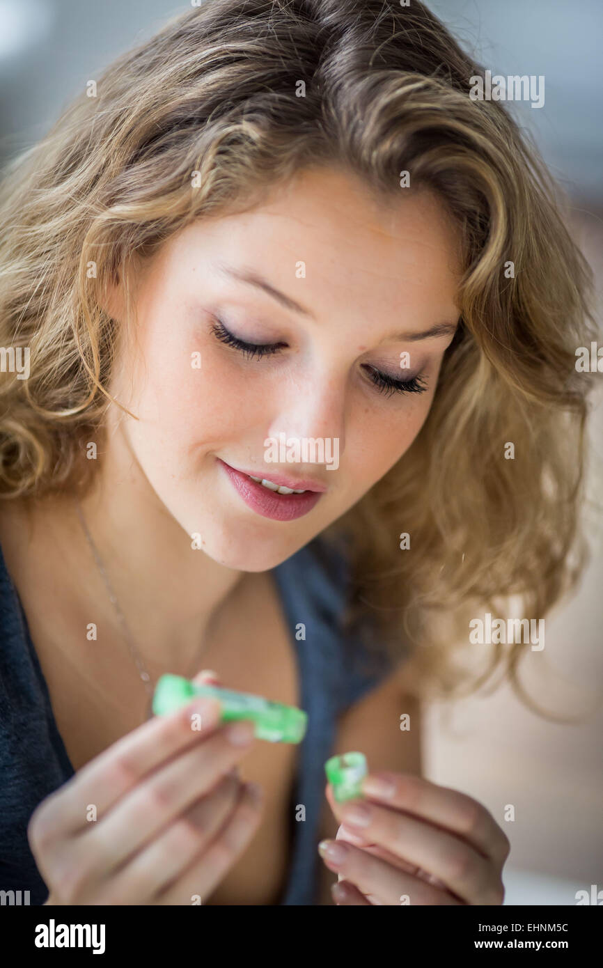 Woman taking homeopathic medicine. Stock Photo