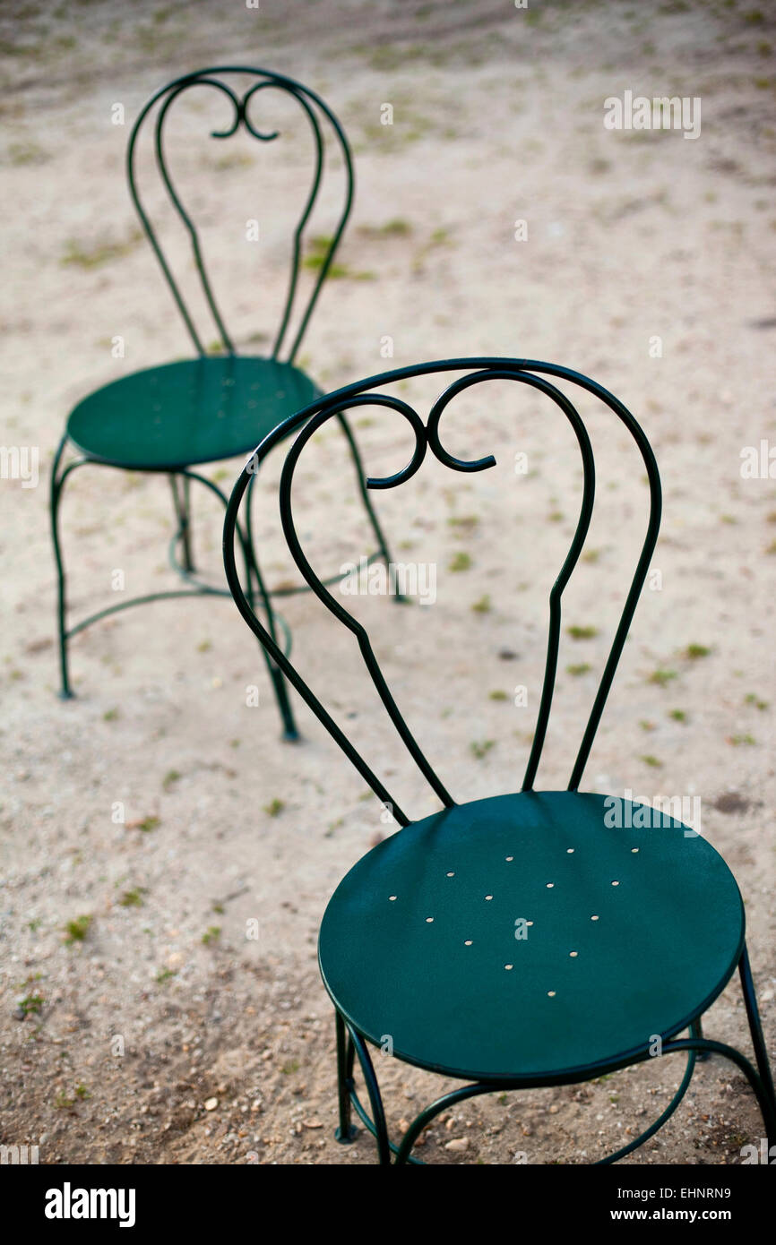 Two green garden chairs in a park Stock Photo Alamy