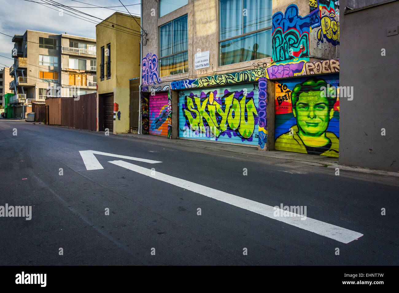 Street art and arrow on pavement in an alley, in Venice Beach, Los