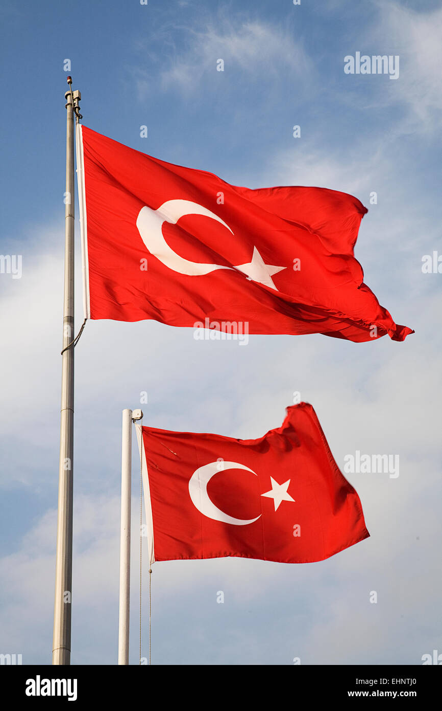 Red Turkish flags with their bright red backdrop featuring the  crescent and star make a colorful display whenever they fly. Stock Photo