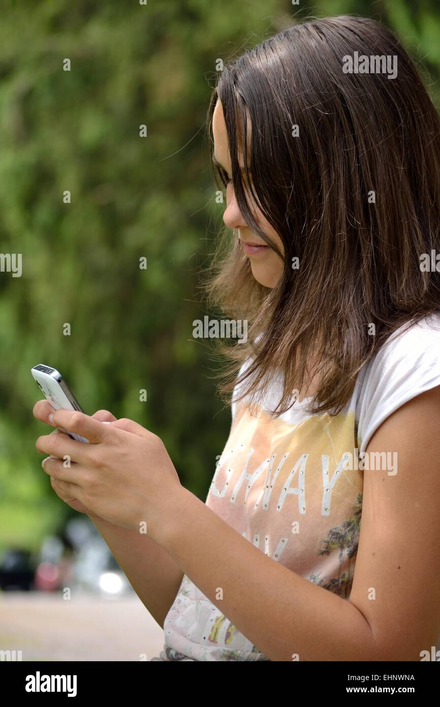 Portrait of teenage when writing sms Stock Photo