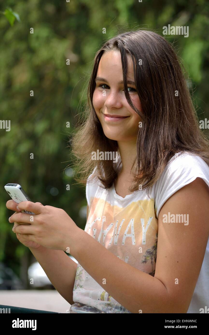 smiling teenager writes sms Stock Photo