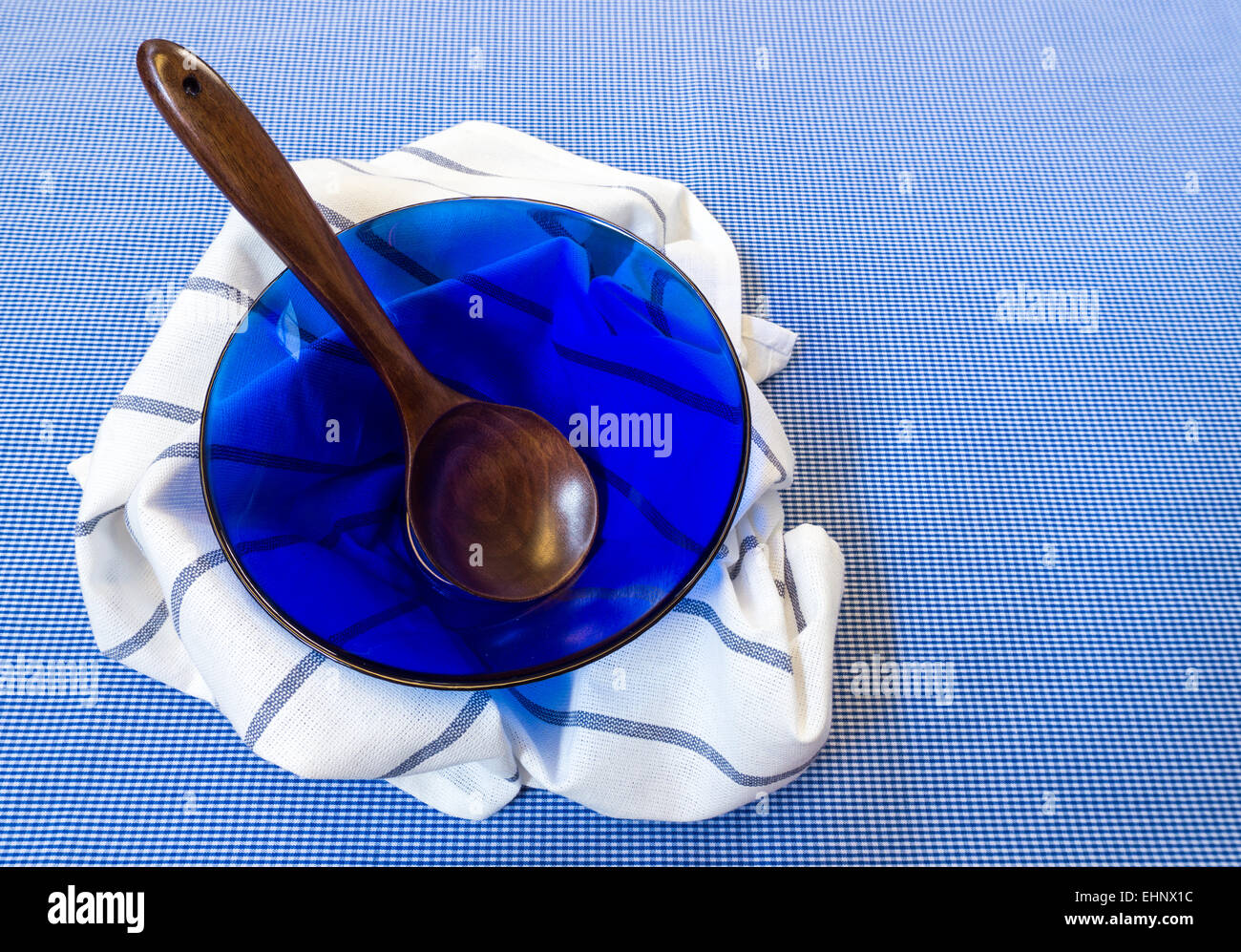 Blue Glass Salad Bowl with Wooden Spoon Cover with White Fabric Placed