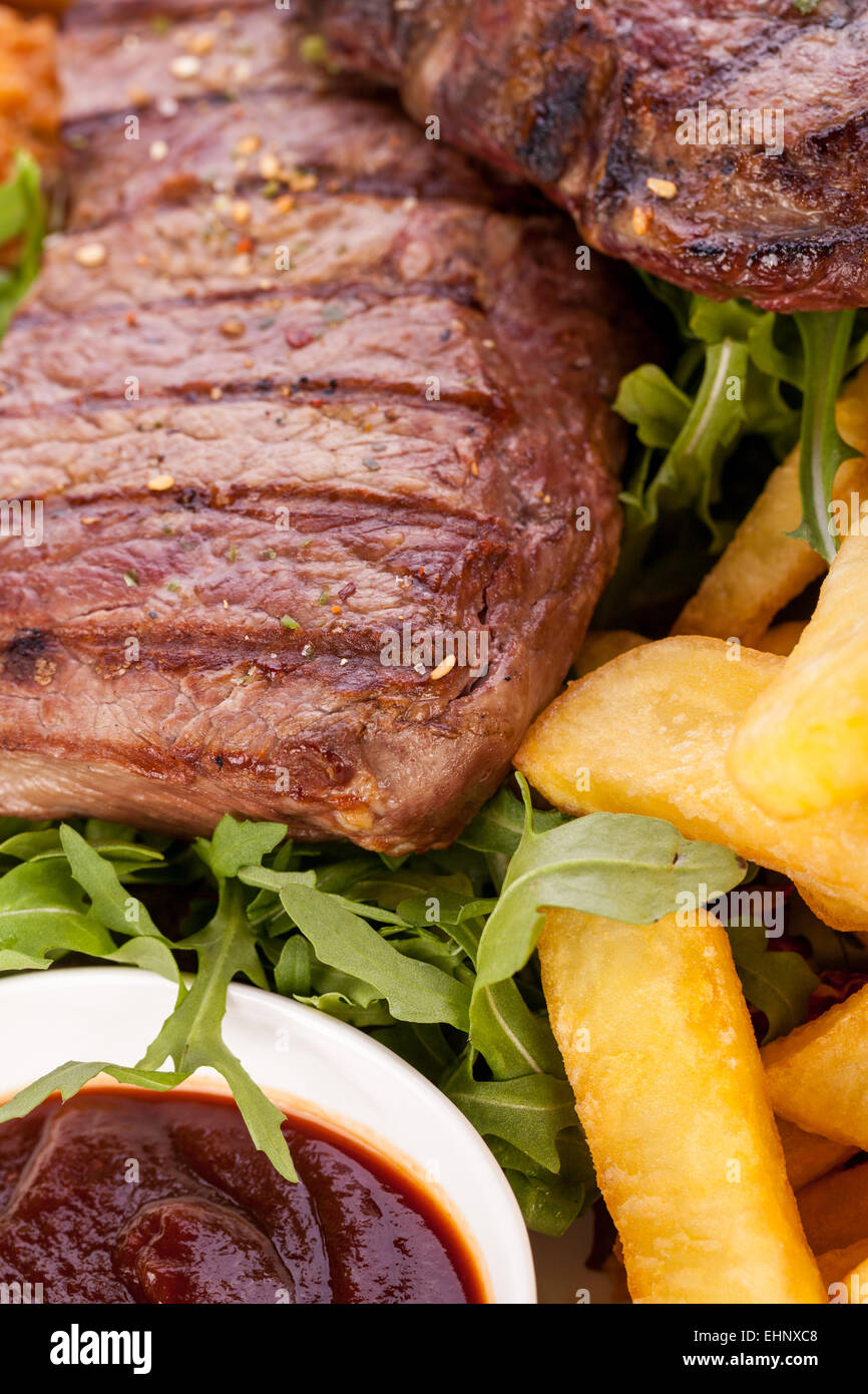 Wholesome platter of mixed meats including grilled steak, crispy