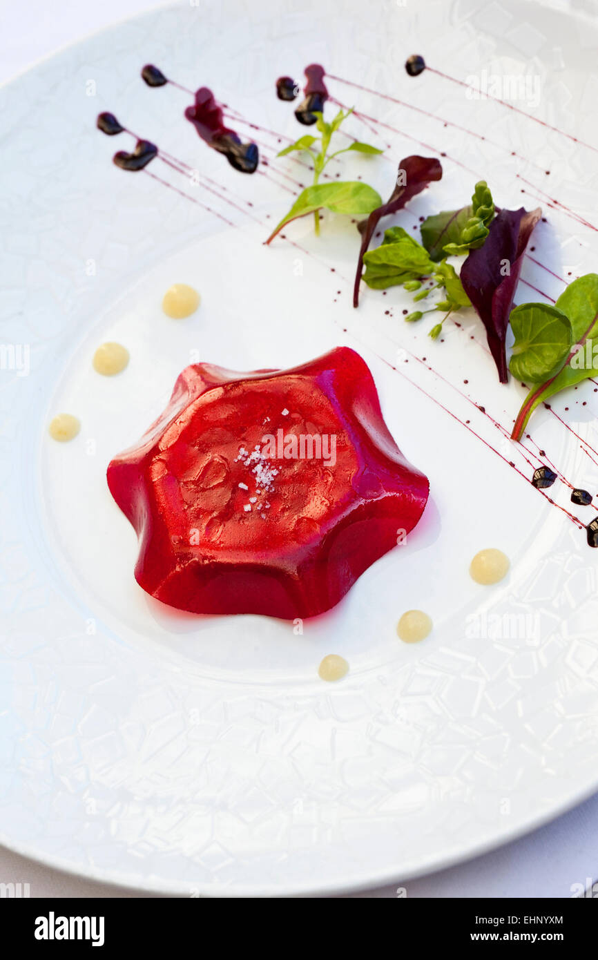 Foie gras and beetroot jelly, green salad and sauce Stock Photo